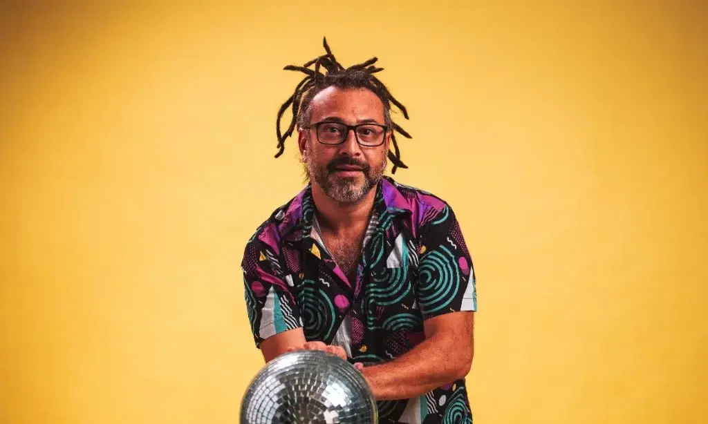 Man with dreads about to bowl a disco ball