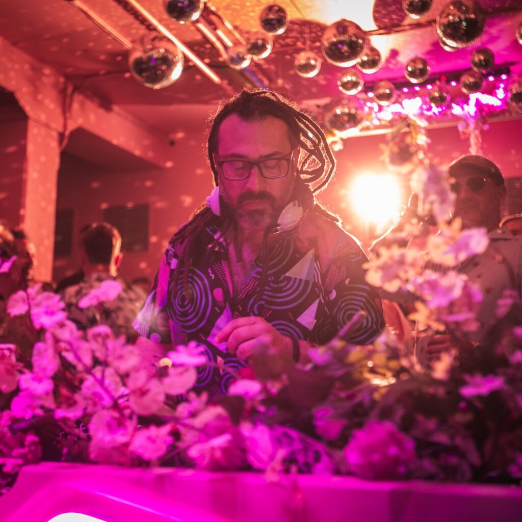 DJing amongst pink flowers