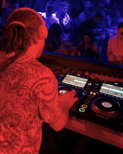 DJ with colourful shirt in neon lights