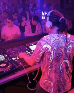 DJ with colourful shirt in neon lights