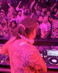 DJ with colourful shirt in neon lights