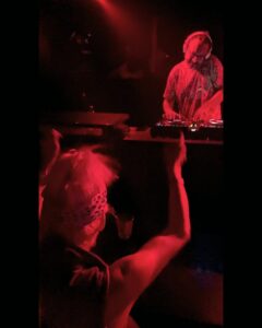 DJ with colourful shirt in neon lights