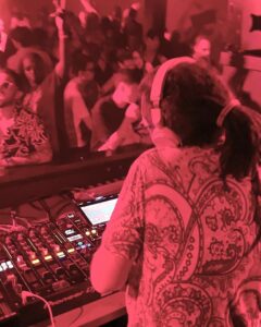 DJ with colourful shirt in neon lights