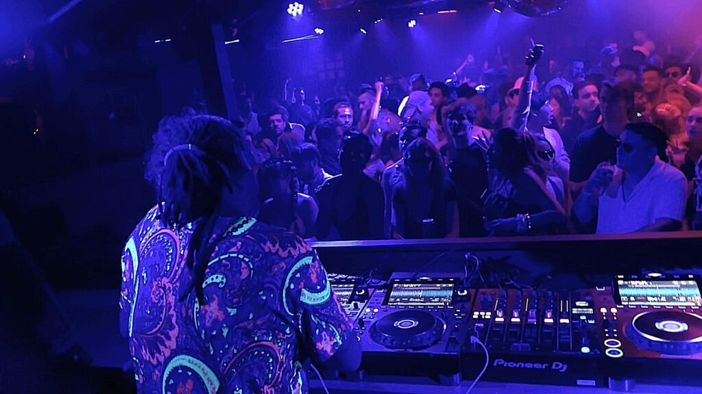 DJ with colourful shirt in neon lights