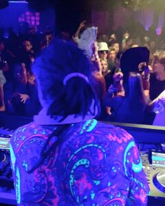 DJ with colourful shirt in neon lights