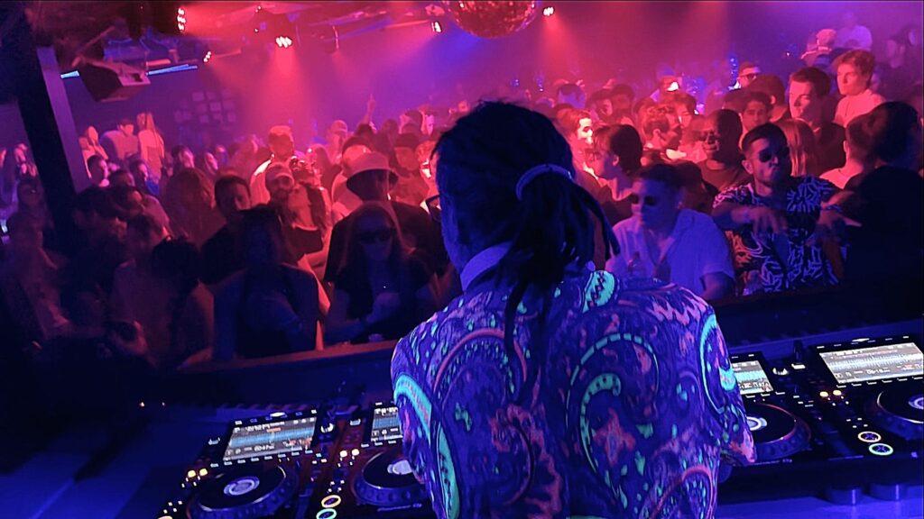 DJ with colourful shirt in neon lights