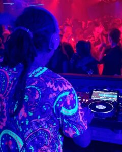 DJ with colourful shirt in neon lights