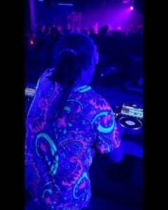 DJ with colourful shirt in neon lights