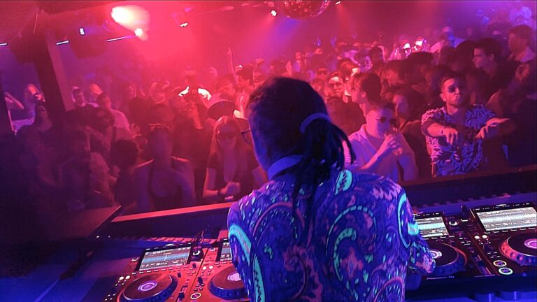 Dj and crowd lit in red